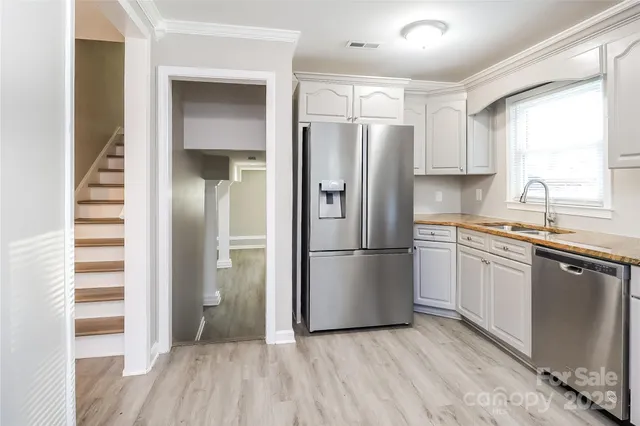 a kitchen with a refrigerator a sink and dishwasher