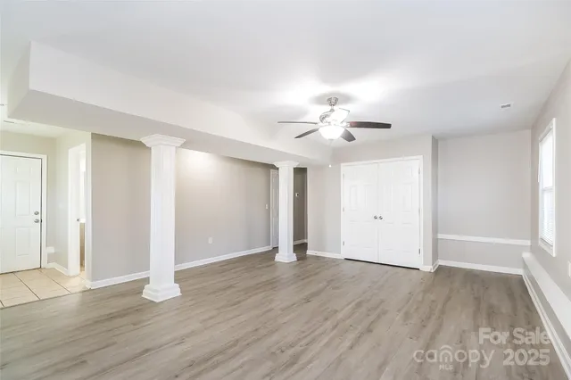 a view of an empty room with wooden floor