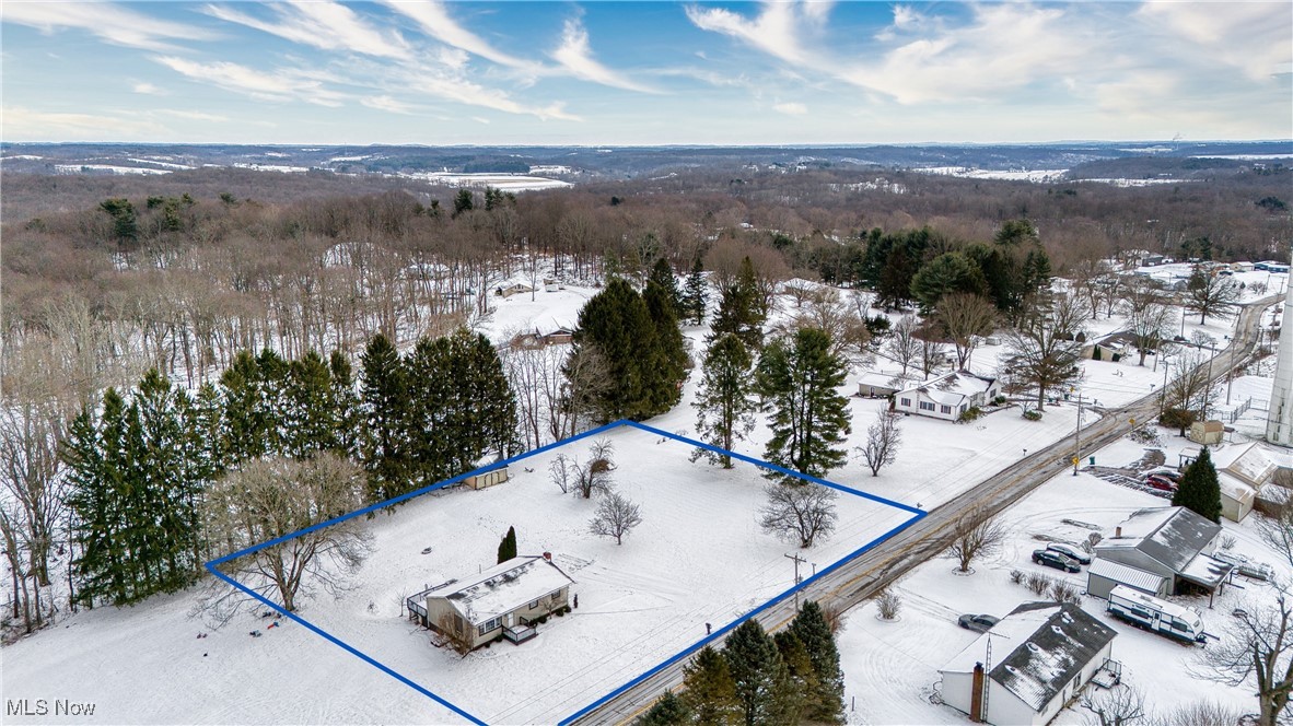 6160 Dresden Road Zanesville, OH 43701 - Photo 5 of 32 Snowy aerial view featuring property parcel outlined and a wooded view