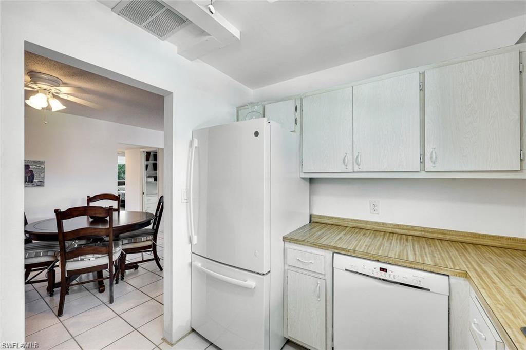 2000 Alamanda Drive, Unit 206 Naples, FL 34102 - Photo 11 of 31 a white refrigerator freezer sitting in a kitchen
