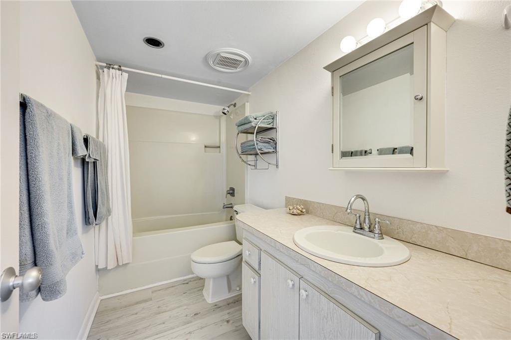 2000 Alamanda Drive, Unit 206 Naples, FL 34102 - Photo 16 of 31 a bathroom with a sink toilet and shower