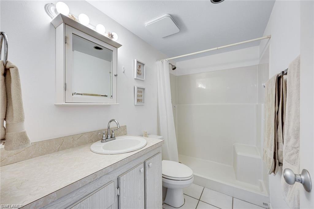 2000 Alamanda Drive, Unit 206 Naples, FL 34102 - Photo 18 of 31 a bathroom with a sink a toilet and shower