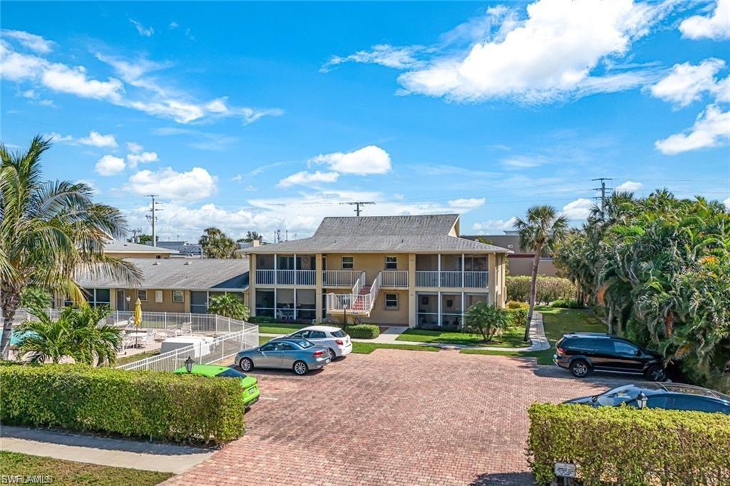 2000 Alamanda Drive, Unit 206 Naples, FL 34102 - Photo 2 of 31 a view of a house with backyard porch and sitting area