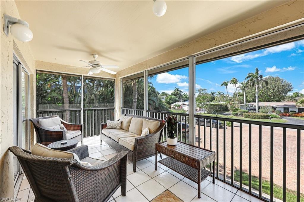 2000 Alamanda Drive, Unit 206 Naples, FL 34102 - Photo 21 of 31 a balcony with furniture and a potted plant