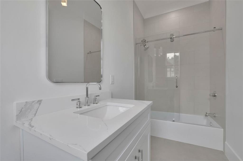 3893 Indian Shoals Road Southeast Bethlehem, GA 30620 - Photo 27 of 63 a bathroom with a sink a shower and a mirror