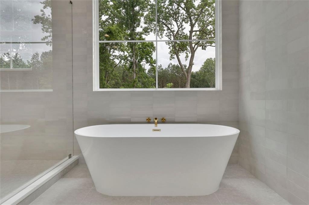 3893 Indian Shoals Road Southeast Bethlehem, GA 30620 - Photo 39 of 63 a white bath tub sitting in a bathroom