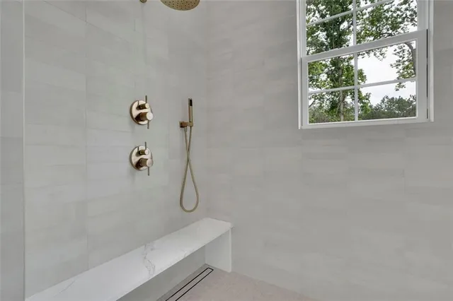 a white bath tub sitting in front of a window