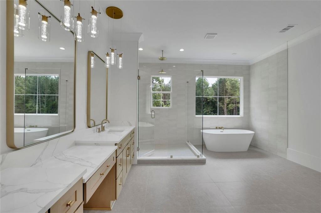 3893 Indian Shoals Road Southeast Bethlehem, GA 30620 - Photo 41 of 63 a bathroom with a granite countertop sink a toilet a mirror and shower