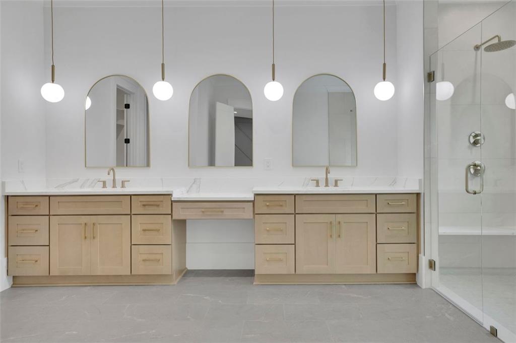 3893 Indian Shoals Road Southeast Bethlehem, GA 30620 - Photo 47 of 63 a spacious bathroom with a granite countertop sink a large mirror and a shower