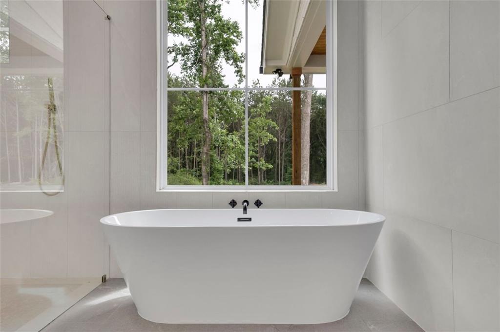 3893 Indian Shoals Road Southeast Bethlehem, GA 30620 - Photo 52 of 63 a white bath tub sitting in front of a window