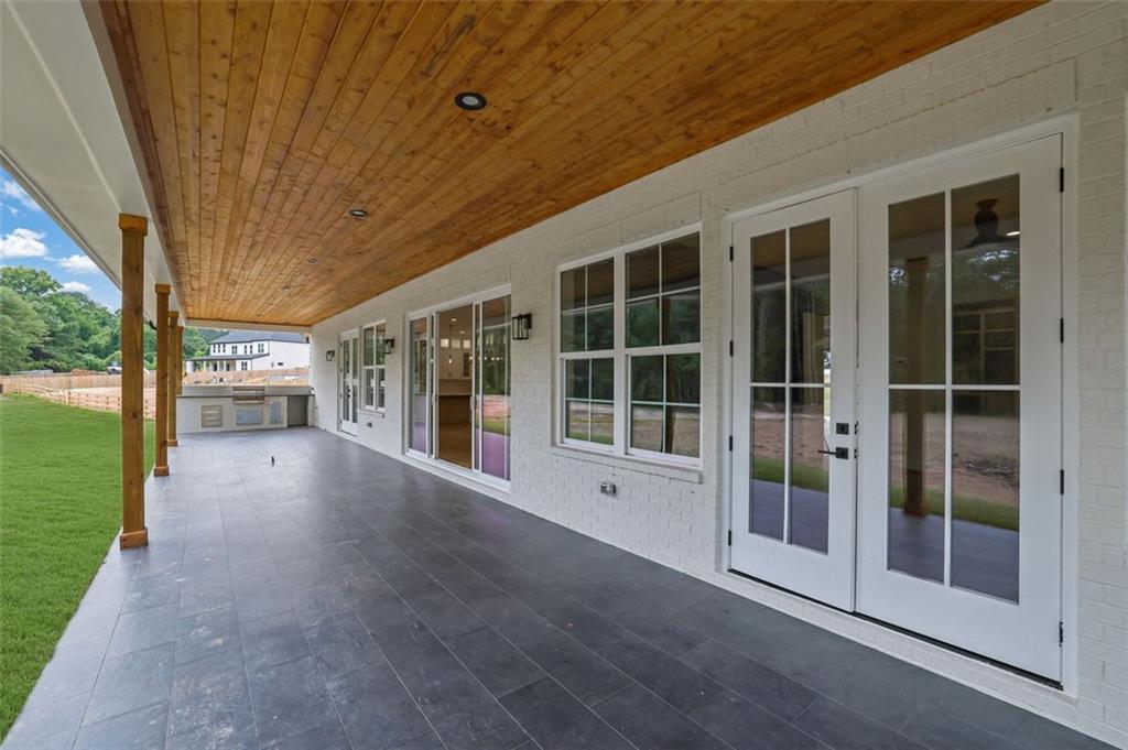3893 Indian Shoals Road Southeast Bethlehem, GA 30620 - Photo 53 of 63 a view of empty room with floor to ceiling window and wooden floor