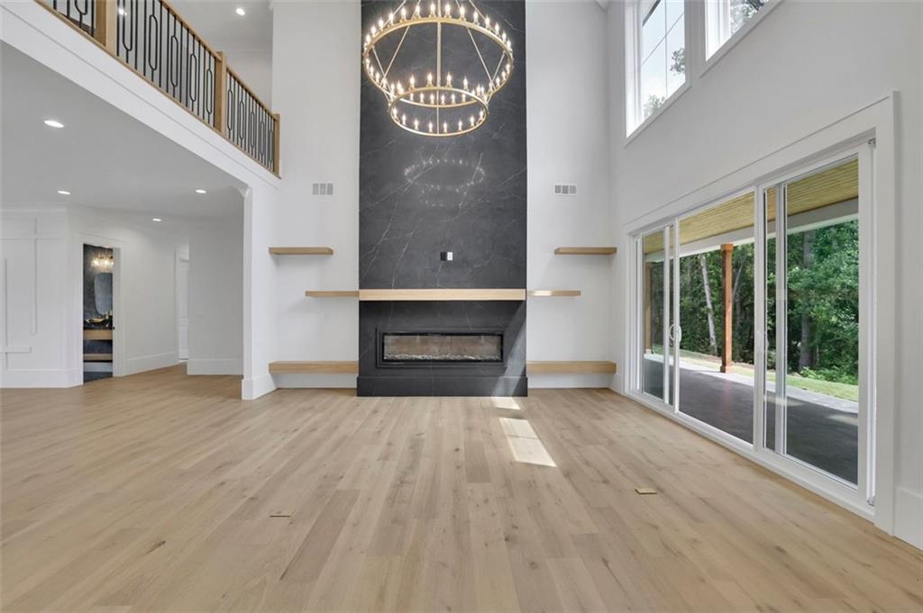 3893 Indian Shoals Road Southeast Bethlehem, GA 30620 - Photo 7 of 63 a view of a livingroom with wooden floor a fireplace and windows