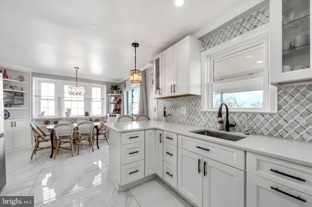 a kitchen with cabinets appliances and a window