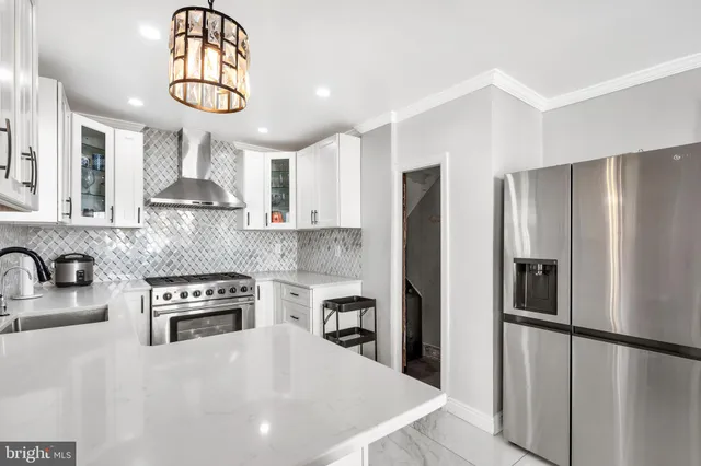 a kitchen with stainless steel appliances granite countertop a refrigerator a stove a sink dishwasher a microwave oven with cabinets and wooden floor