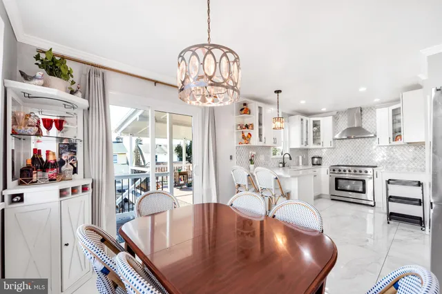 a living room with kitchen island furniture and a chandelier