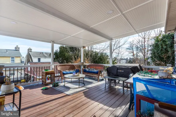 a living room with furniture a wooden floor and next to a yard