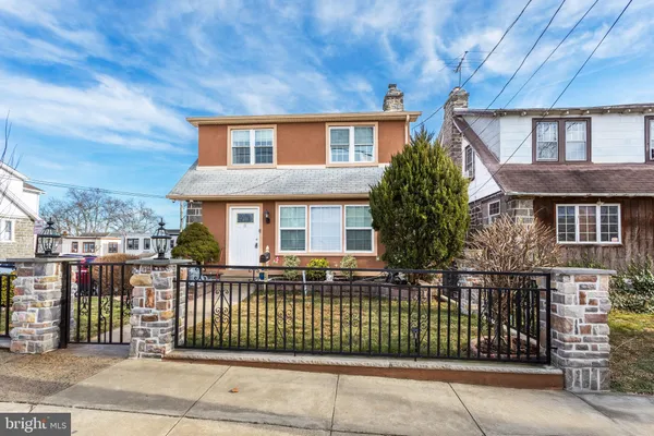 a front view of a house with a fence