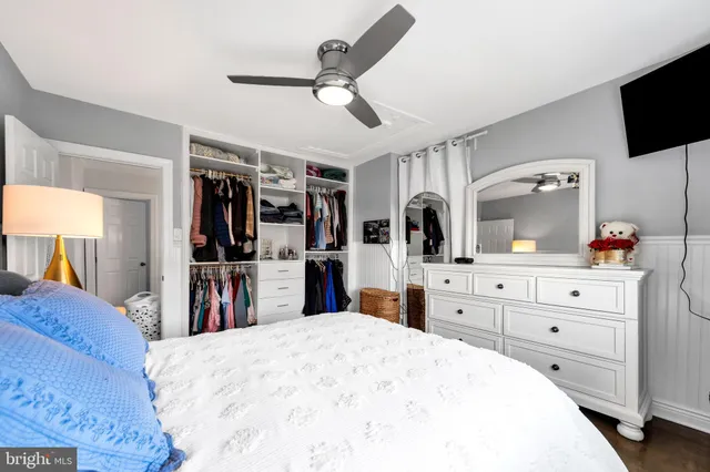 a bed room with a bed and a television