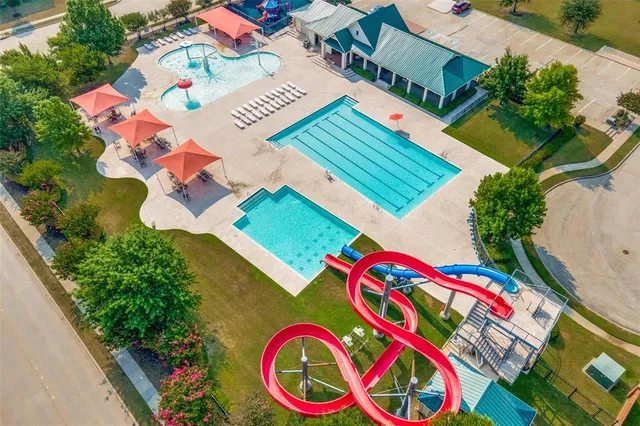 an aerial view of a swimming pool patio and outdoor seating