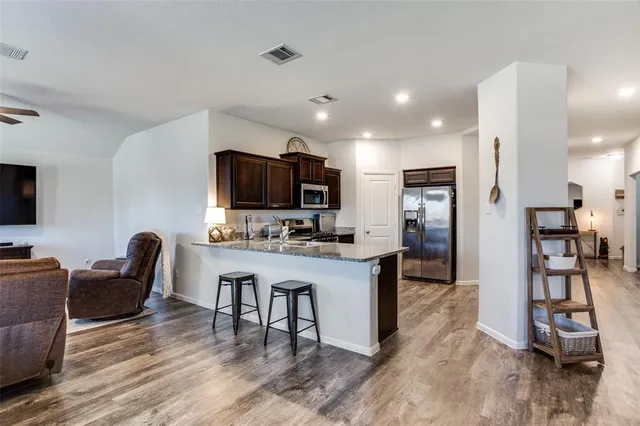 a kitchen with granite countertop lots of counter top space and stainless steel appliances