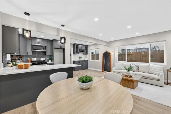 a living room with kitchen island furniture and a large window