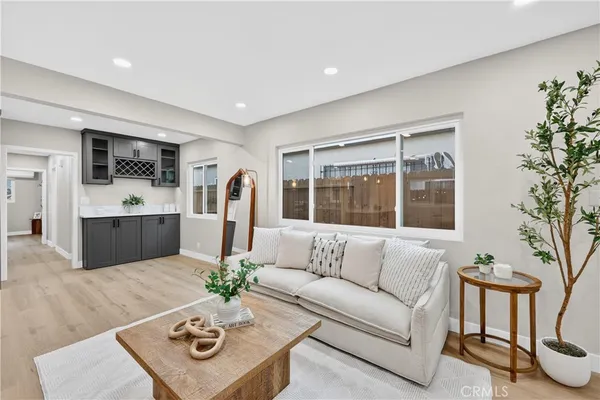 a living room with furniture potted plant and a table
