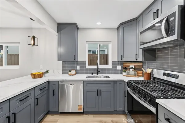 a kitchen with a sink stove and cabinets