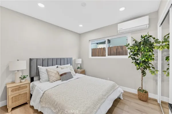 a bedroom with a bed and a potted plant