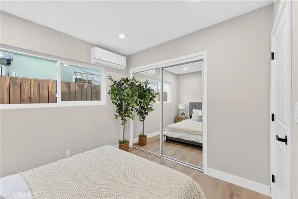 a bedroom with a bed and a potted plant