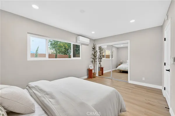 a bed room with a bed and a chair