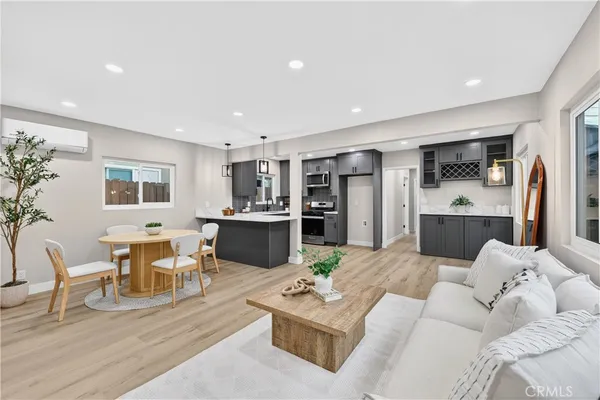 a living room with furniture and kitchen view