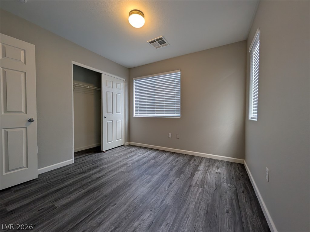 10308 Faustine Avenue Las Vegas, NV 89129 - Photo 25 of 28 A well-lit bedroom features durable laminate flooring and a spacious closet.