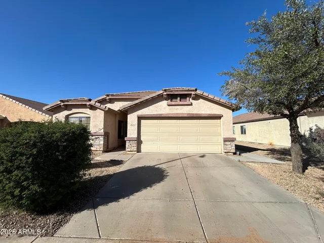 a view of a car parked in front of a house with a yard