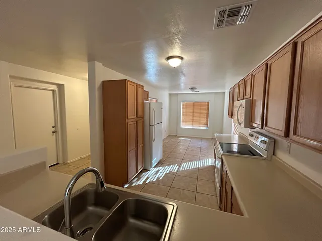 a bathroom with double vanity sink a mirror and a bathtub