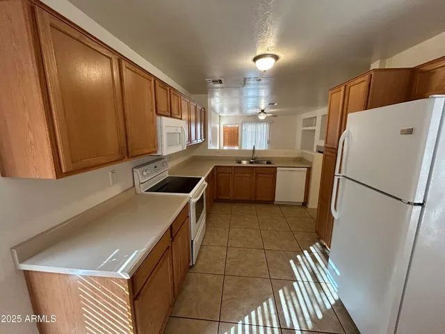a kitchen with a refrigerator sink and stove