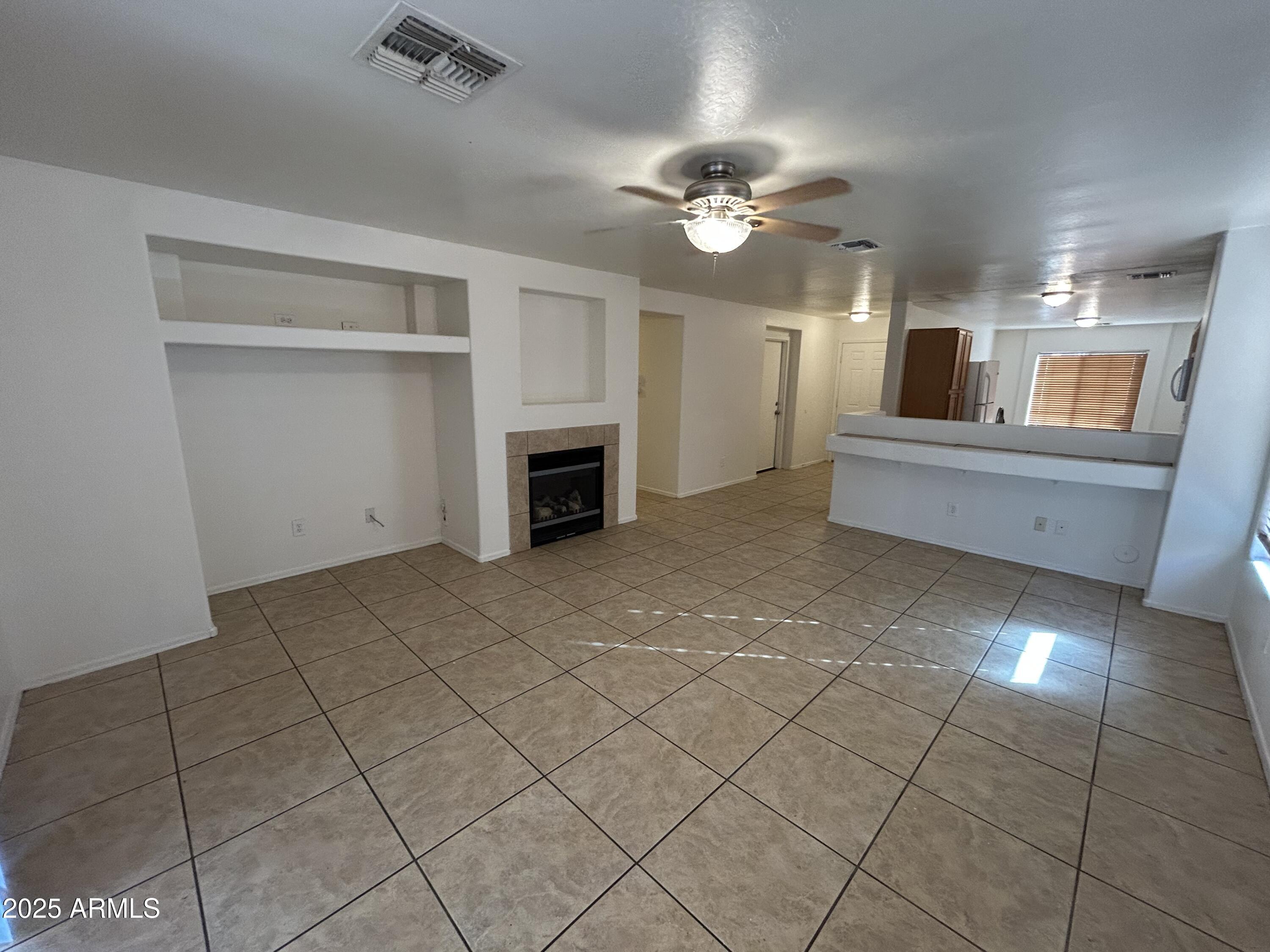 1602 West Alta Vista Road Phoenix, AZ 85041 - Photo 6 of 13 a living room with furniture and a fireplace