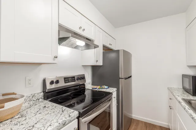 a kitchen with a stove and a refrigerator