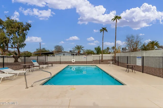 a view of a swimming pool with chairs
