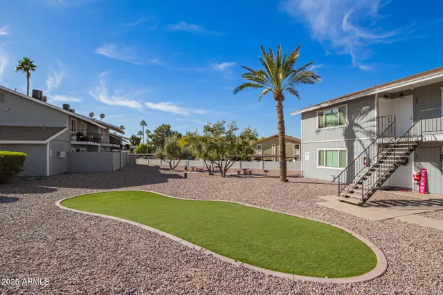 a view of a backyard with swimming pool