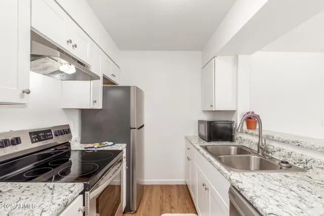 a kitchen with a sink stove and refrigerator