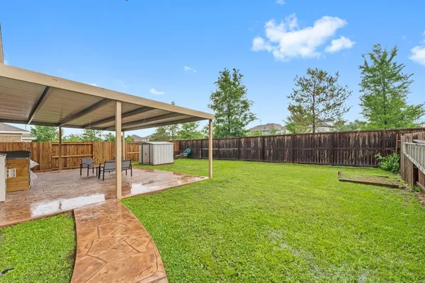 a view of a backyard with sitting area
