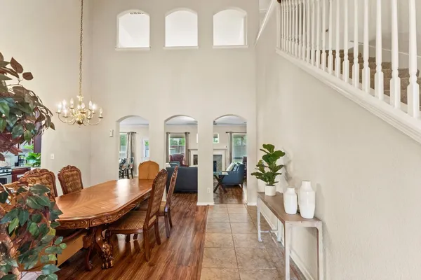 a view of a dining room with furniture and chandelier