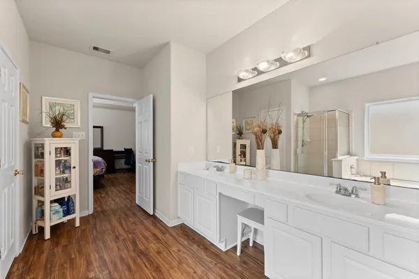 a spacious bathroom with a double vanity sink and a mirror