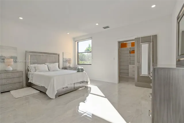 a spacious bedroom with a bed and a table