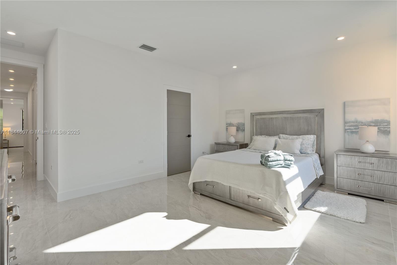 2887 Southwest 33rd Avenue Miami, FL 33133 - Photo 17 of 38 a bedroom with a large bed and a view of bathroom