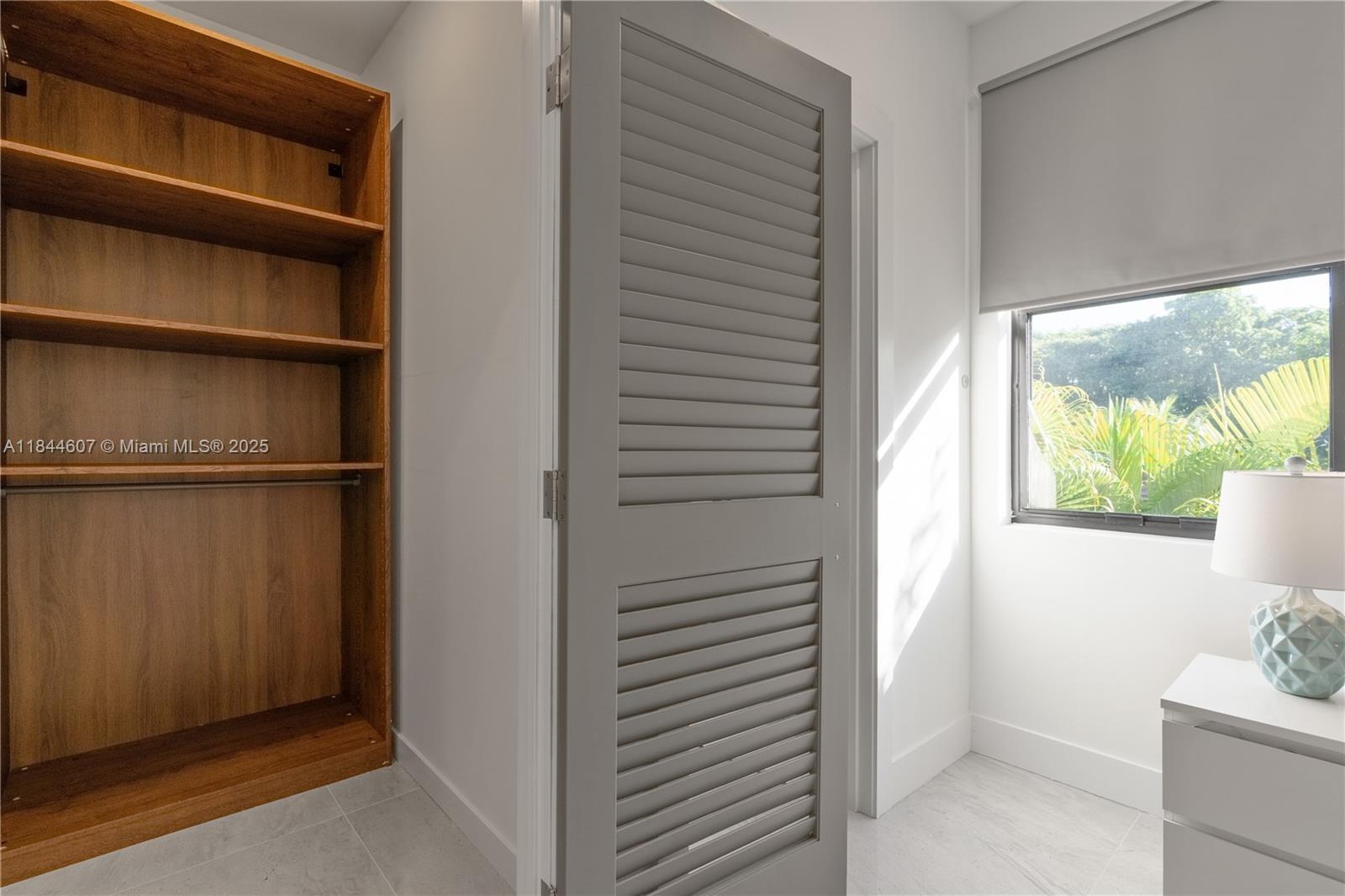 2887 Southwest 33rd Avenue Miami, FL 33133 - Photo 22 of 38 a view of an empty room with a window and a bathroom