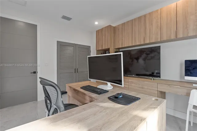 a kitchen with a table and chairs