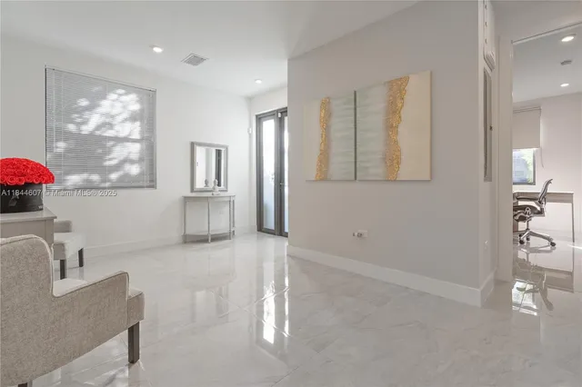 a kitchen with white cabinets and window