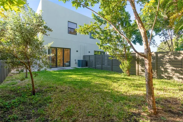 a backyard of a house with lots of green space