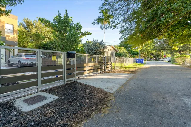 a view of a backyard with wooden fence